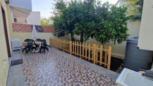 a wooden fence with two chairs and a tree at Nettuno in Messina
