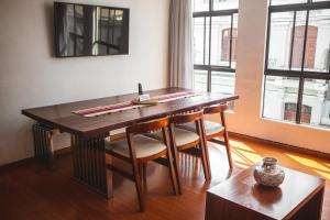 a dining room table with four chairs and a window at HISTORIC CENTER PERUVIAN CLASIC Apartment in Lima