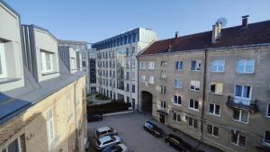 a view of a parking lot in a city with buildings at G-47 Near the Parliament - Self check in in Vilnius