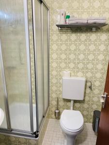 a bathroom with a toilet and a glass shower at Auf Mühlenfeld in Heimbach +5 photos