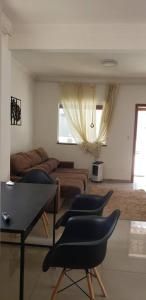 ein Wohnzimmer mit 4 Stühlen und einem Sofa in der Unterkunft Casa com Spa. in Lagoa Santa