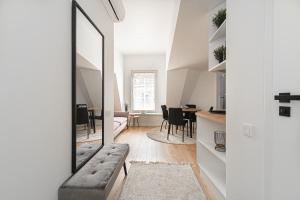 a living room with a mirror and a couch at G-47 Near the Parliament - Self check in in Vilnius