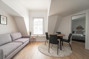a living room with a couch and a table at G-47 Near the Parliament - Self check in in Vilnius
