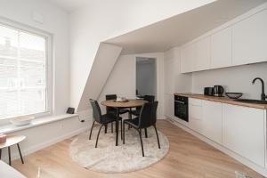 a kitchen and dining room with a table and chairs at G-47 Near the Parliament - Self check in in Vilnius +29 photos