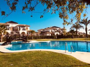 a swimming pool in front of some houses at Hestía Vera Thalassa SPA Tu hogar lejos de casa in Vera