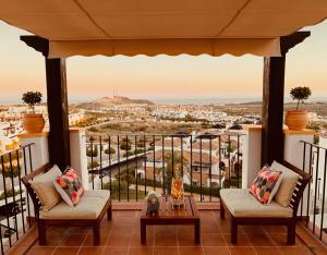 a balcony with a view of a city at Hestía Vera Thalassa SPA Tu hogar lejos de casa in Vera