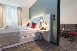 a hotel room with two beds and a mirror at Riu Plaza Berlin in Berlin