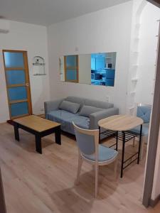 a living room with a couch and a table at Lovely 3 rooms Nice riquier next to Port with AC! in Nice