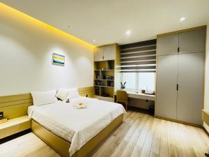 a bedroom with a bed and a desk in it at Bibi’s home in Danang
