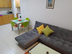 a living room with a couch and a table at Coral View in Peyia