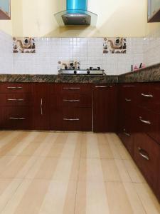 a kitchen with wooden cabinets and a counter top at Vara in Varanasi