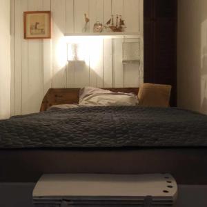 a bed sitting in a room with a window at Hangulatos kis lakás a belvároshoz közel in Szeged