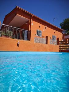 a building with a pool of water in front of it at Relax House Barcelone in Sant Esteve Sesrovires