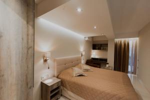 a bedroom with a large bed in a room at AKRON Luxury Holidays in Ancient Epidauros