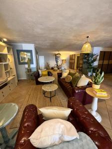 a living room with leather couches and tables at Boutique Villa Leicht & Friends in Adeje