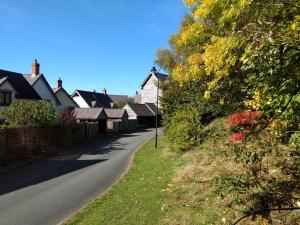 a row of houses on a residential street at The Studio, Upper House Farm, Crickhowell with Double Garage and Free Parking in Crickhowell