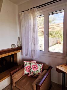 a living room with a couch and a window at Elaia country living in Galatas