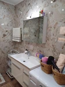 a bathroom with a sink and a mirror at Apartment Efi in N&eacute;a P&eacute;ramos