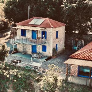 an aerial view of a stone house with blue windows at Rocksecret Edge in Kalamata