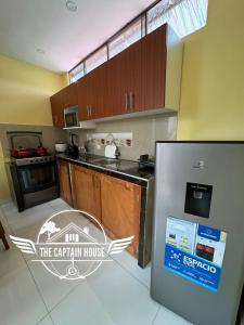 a kitchen with a sign that says the captain house at The Captain House in Pucallpa