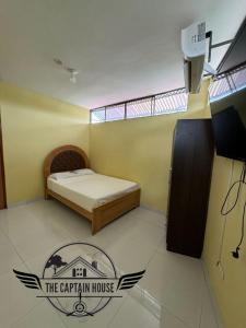a small room with a bed and a balcony at The Captain House in Pucallpa