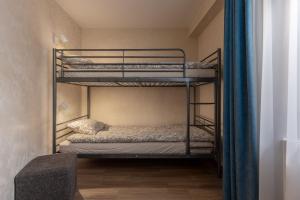 a bedroom with two bunk beds in a room at Lab1 House in Rīga