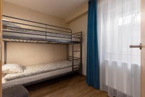 a bedroom with two bunk beds and a window at Lab1 House in Rīga