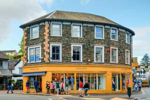 a group of people walking in front of a building at Victoria Loft in Bowness-on-Windermere