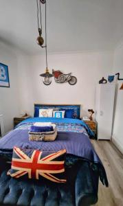 a bedroom with a king sized bed with british flags on it at Luxury ApArt Apartment Bedford Embankment & Free parking in Bedford
