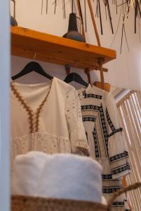 a shelf with someones clothes on it at Fisherman House in Klima