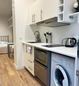 a kitchen with a washer and a washing machine at Eiffel Tower studio with patio in Paris