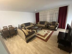 a living room with two couches and a table at Banes me qera in Gjilan