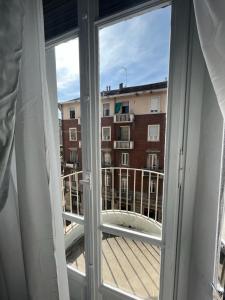 a window with a view of a building at Da Amélie - Casa Giovanni a pochi passi dalla fermata Metro Racconigi di Torino in Turin