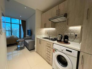 a kitchen with a washing machine in a kitchen at Seven Hotel & Apartments at the Palm Jumeirah Studio apartment with awesome view in Dubai