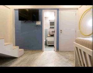 a room with a bed and a television on a wall at Top-floor Oceanfront Designer Condo In Bandra in Mumbai