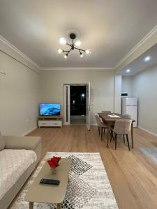 a living room with a couch and a table at Villa VSV:Second Flat+Parking in Bathore +1 photo