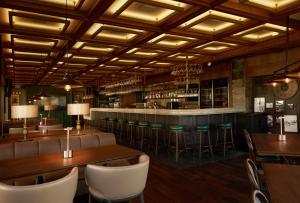 a restaurant with tables and chairs and a bar at Idyll Holiday Homes in Kyrenia