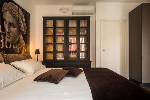 a bedroom with a bed with a large headboard at Cagliari Luxury Design Rooms in Cagliari