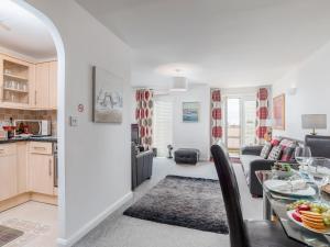 a kitchen and living room with a table and a couch at 14 Belvedere Court in Paignton