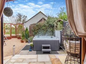 a garden with a hot tub in a yard at Easthorpe Retreat in Copford