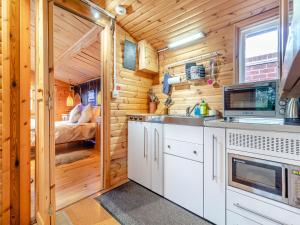 a kitchen with a sink and a microwave at Easthorpe Retreat in Copford