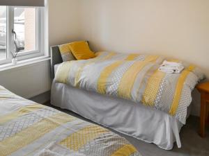 a bedroom with two beds and a window at Carolyn House in Ellington