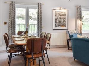 a dining room with a table and chairs at Pilot Me Cottage in Staithes