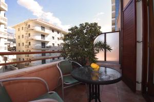 a table on a balcony with a view of a building at So rooms city centre in Budva