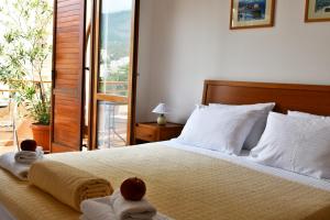 a bedroom with a bed with towels and a balcony at So rooms city centre in Budva +39 photos