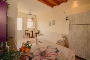 a living room with a couch and a table at Evgenias House Ancient Olympia - Happy Rentals in Olympia