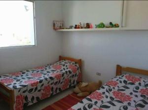 a bedroom with two beds and a teddy bear on the floor at Mahdia best Beach in Mahdia