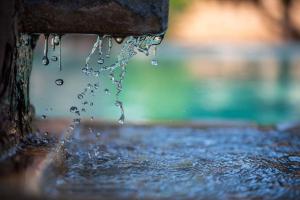 a close up of water pouring out of a water fountain at Calvocoressi Estate in Chios