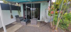 a screened in porch of a house with chairs at Studio avec superbe vue in Entre-Deux
