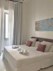 a white bed with towels on it in a bedroom at Veneto Serviced Apartment by SupaStays in Rome